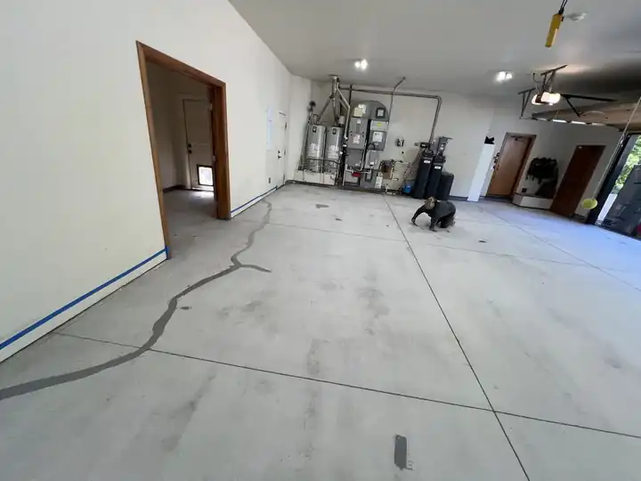 Cracks filled and ground flush in a 3-car garage before coating