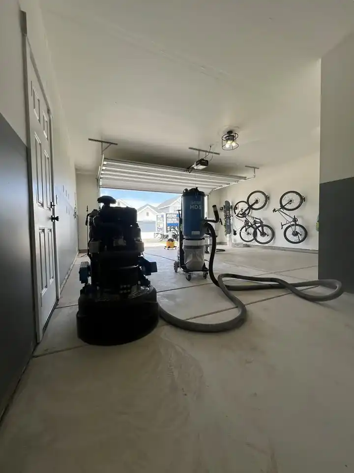 Resin4U owner diamond-grinding a garage slab with a Bartell Global grinder